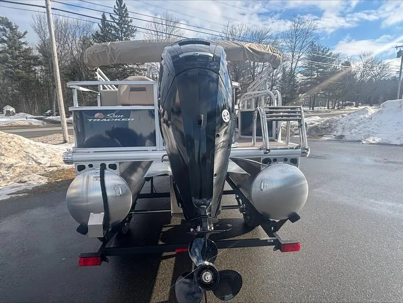 Slide: The Image of 2025 Sun Tracker BB 18 DLX pontoon boat with outboard motor, parked on snowy pavement. - 9