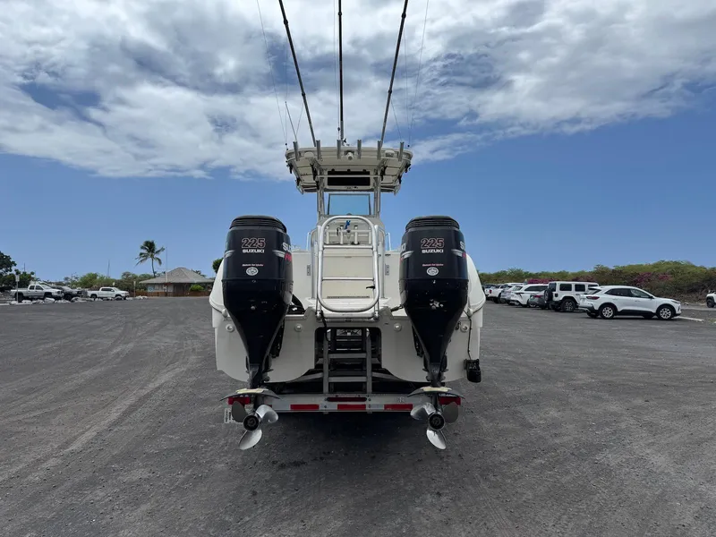 Slide: The Image of 2009 World Cat 270 TE boat with twin engines on a trailer, parked under a cloudy sky. - 10