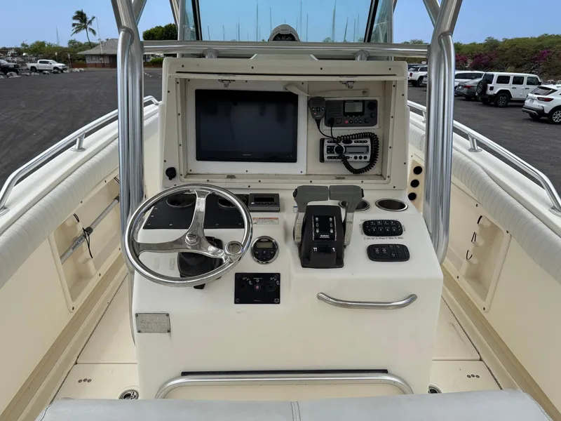 Slide: The Image of 2009 World Cat 270 TE boat console with steering wheel and navigation equipment. - 15