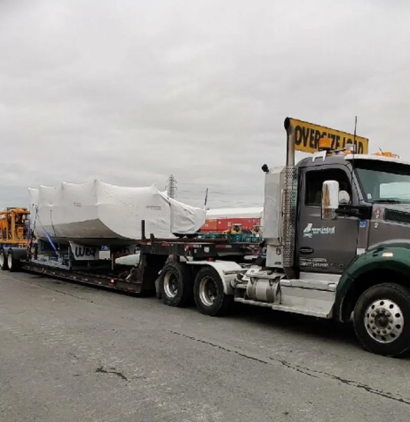 Slide: The Image of Truck transporting 2016 Offshore Racing Van Munster Boats Fred Barrett 35, covered, on overcast day. - 24