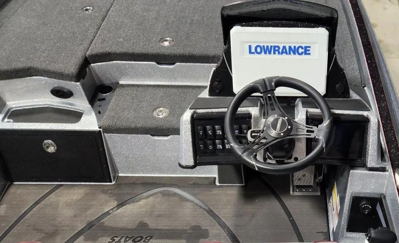 Slide: The Image of 2025 Triton 20XP Patriot boat dashboard with Lowrance display and steering wheel. - 5