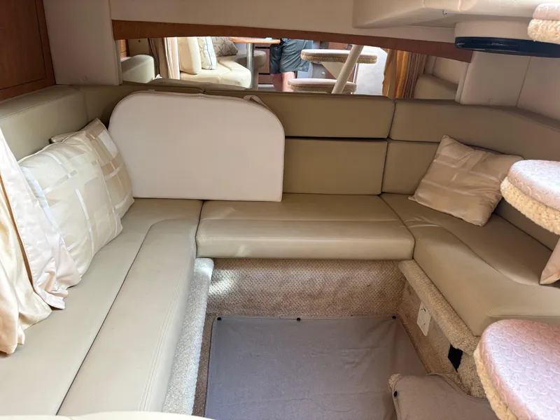 Slide: The Image of Interior of 2006 Sea Ray 320 Sundancer with beige seating and cushions. - 11