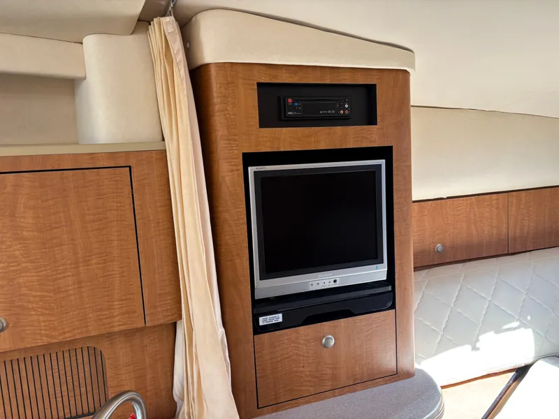 Slide: The Image of Interior of 2006 Sea Ray 320 Sundancer with built-in TV and wood cabinetry. - 14