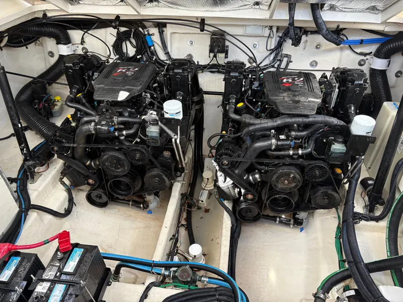 Slide: The Image of Engine room of a 2006 Sea Ray 320 Sundancer with twin motors and visible wiring. - 23