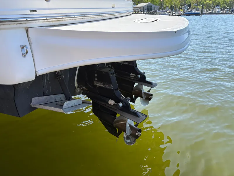 Slide: The Image of 2006 Sea Ray 320 Sundancer boat stern with dual propellers in water. - 24