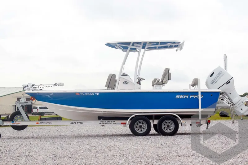 Slide: The Image of 2023 Sea Pro 208 Bay boat on trailer, blue and white design, side view. - 14