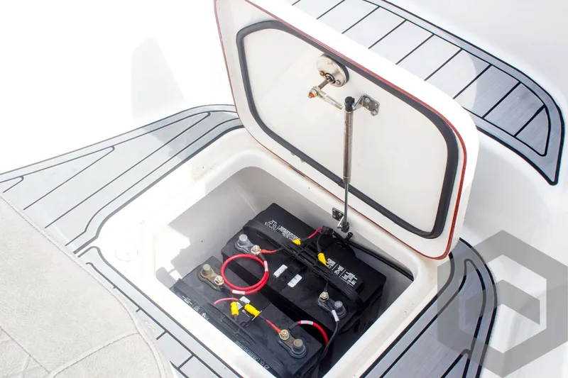 Slide: The Image of 2023 Sea Pro 208 Bay boat battery compartment with dual batteries and wiring. - 31