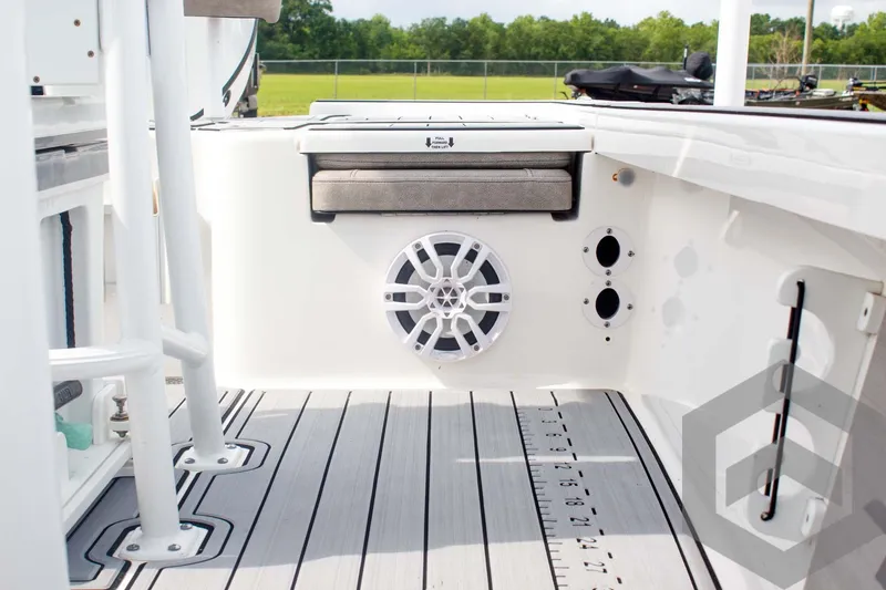 Slide: The Image of 2023 Sea Pro 208 Bay boat interior with speaker and cushioned seating. - 34