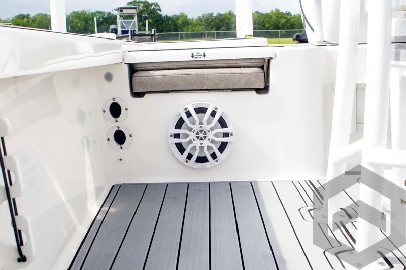 Slide: The Image of 2023 Sea Pro 208 Bay boat interior with speaker and cushioned seat. - 35