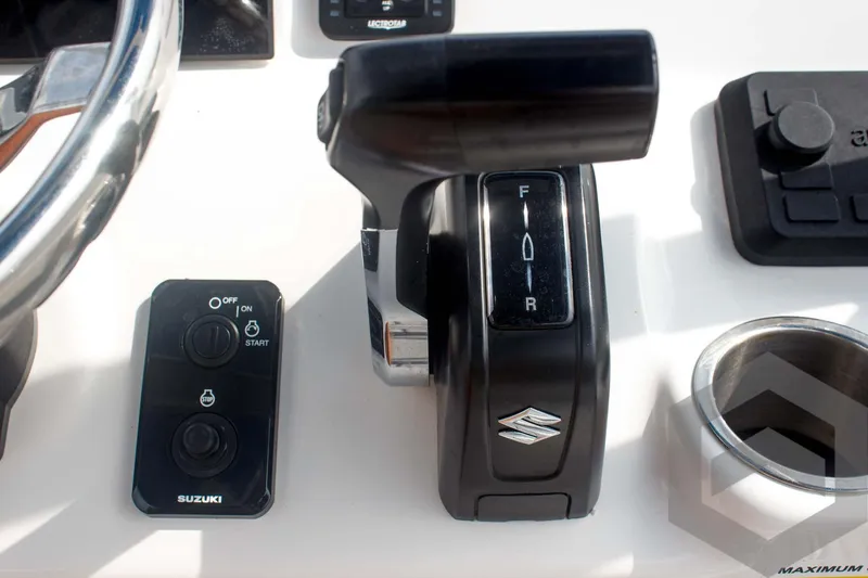 Slide: The Image of 2023 Sea Pro 208 Bay boat controls with Suzuki throttle and steering wheel. - 45