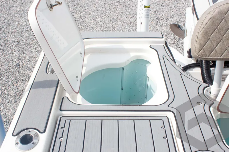 Slide: The Image of 2023 Sea Pro 208 Bay boat livewell with open lid, showcasing interior design. - 48