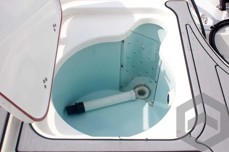 Slide: The Image of 2023 Sea Pro 208 Bay boat livewell with open lid and drainage pipe. - 49