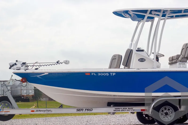 Slide: The Image of 2023 Sea Pro 208 Bay boat on trailer, blue and white design, side view. - 6