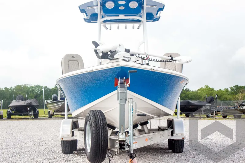 Slide: The Image of 2023 Sea Pro 208 Bay boat on trailer, front view, blue hull, parked outdoors. - 8