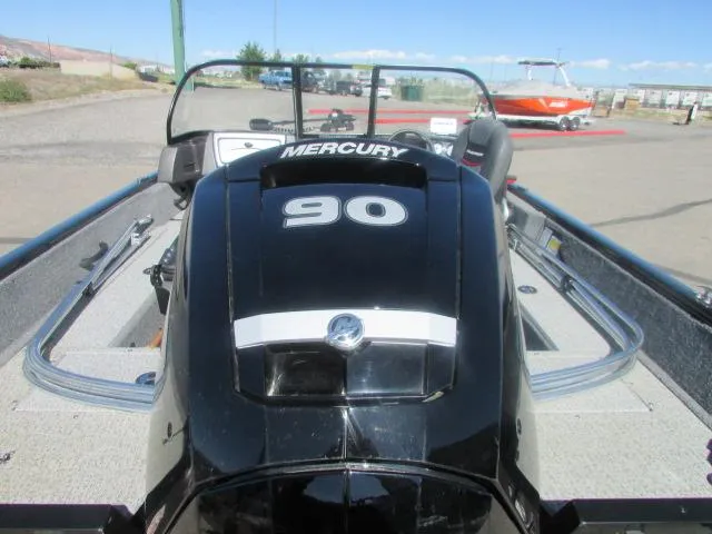 Slide: The Image of 2023 Tracker Pro Guide V16WT boat with Mercury 90 engine, parked outdoors. - 5