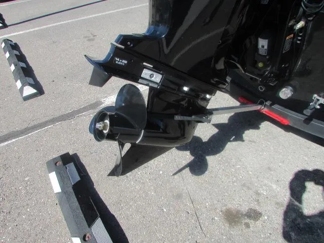 Slide: The Image of 2023 Tracker Pro Guide V16WT boat motor and propeller on pavement. - 9