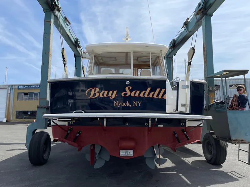 Slide: The Image of 2005 Sabre 38 Hardtop Express boat named "Bay Saddle" in a boatyard lift. - 10