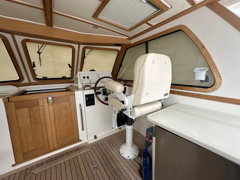 Slide: The Image of 2005 Sabre 38 Hardtop Express helm with wooden accents and captain's chair. - 12