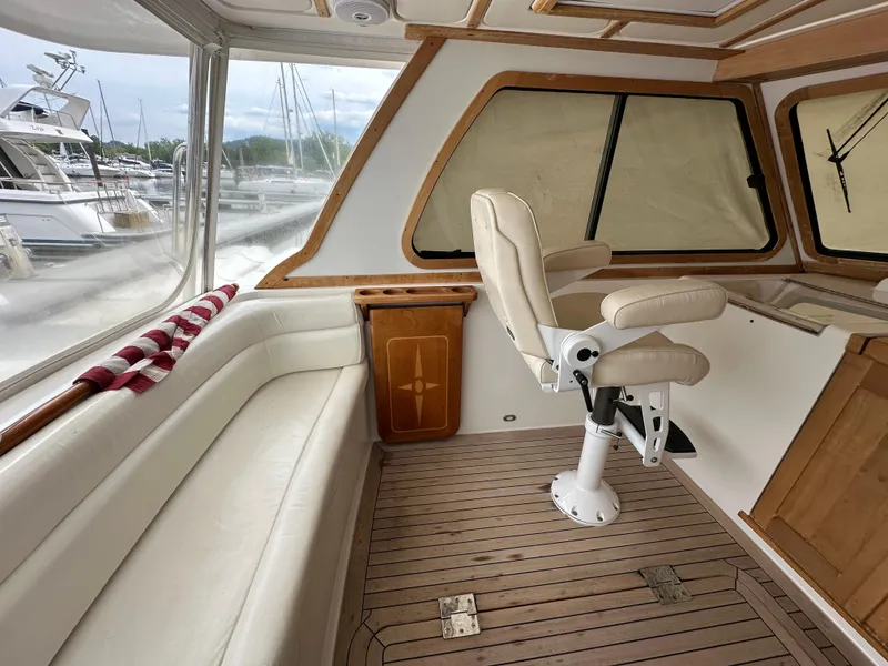 Slide: The Image of 2005 Sabre 38 Hardtop Express interior with helm chair and seating area. - 13