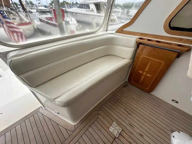 Slide: The Image of 2005 Sabre 38 Hardtop Express interior with cushioned seating and wooden accents. - 14