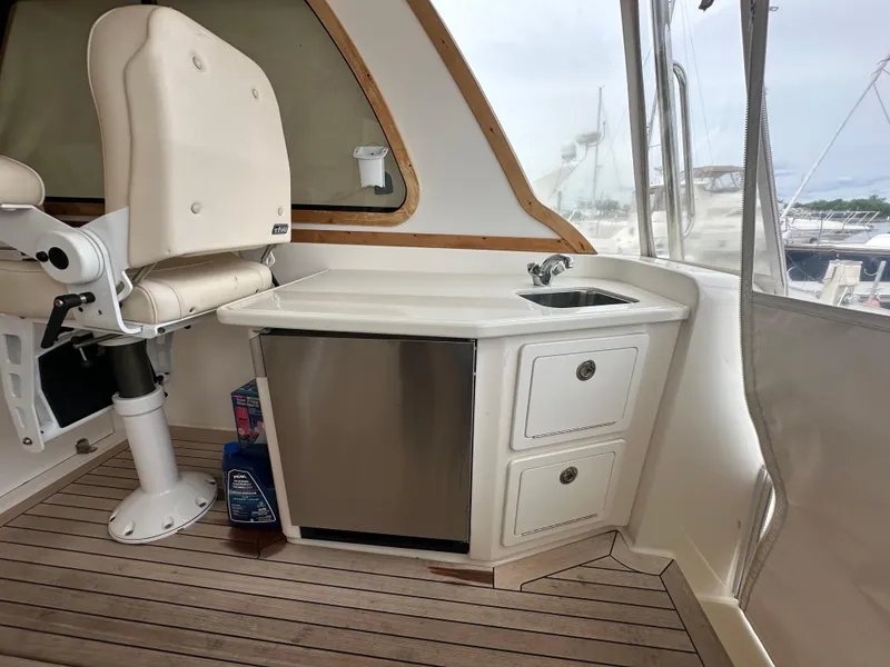 Slide: The Image of 2005 Sabre 38 Hardtop Express interior with chair, sink, and storage drawers. - 15