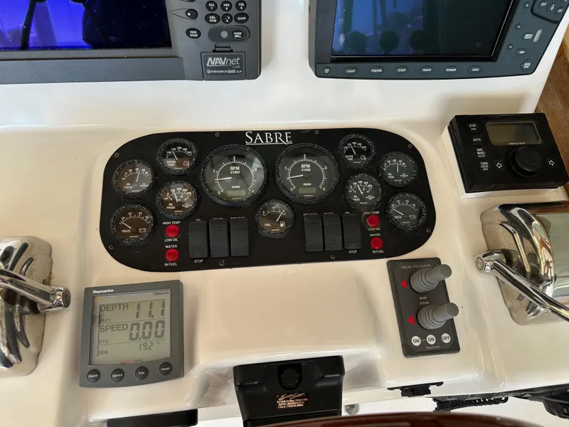 Slide: The Image of Control panel of a 2005 Sabre 38 Hardtop Express boat with various gauges and displays. - 18