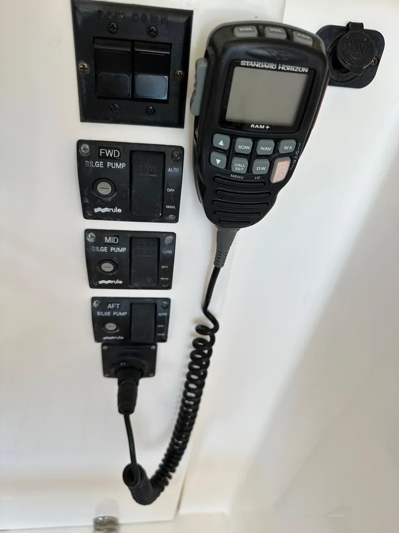 Slide: The Image of 2005 Sabre 38 Hardtop Express control panel with radio and bilge pump switches. - 19