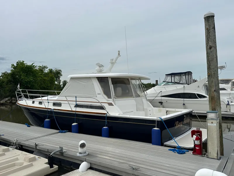 Slide: The Image of 2005 Sabre 38 Hardtop Express docked at marina, side view. - 2