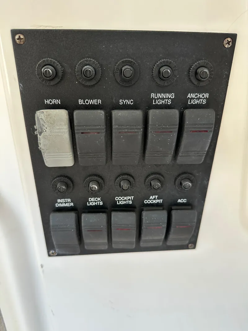 Slide: The Image of Control panel of a 2005 Sabre 38 Hardtop Express boat with labeled switches. - 20