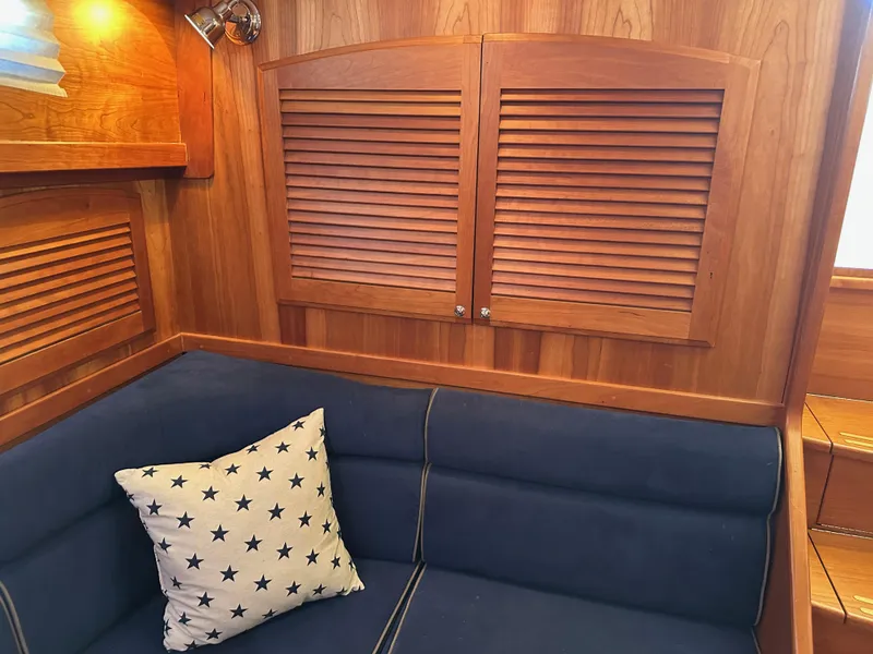 Slide: The Image of Interior of 2005 Sabre 38 Hardtop Express with wooden paneling and blue cushioned seating. - 22