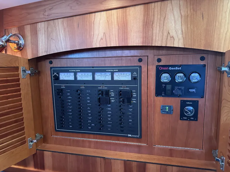 Slide: The Image of Electrical panel on a 2005 Sabre 38 Hardtop Express boat, featuring Onan GenSet controls. - 23