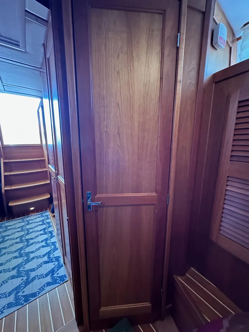 Slide: The Image of Interior of 2005 Sabre 38 Hardtop Express, featuring wooden door and stairs. - 31