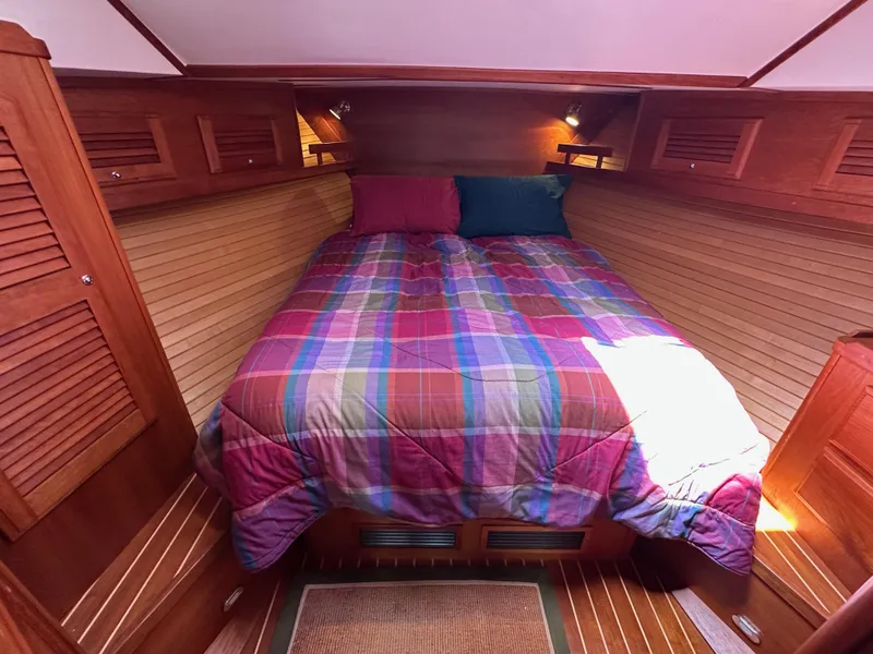 Slide: The Image of Cozy cabin interior of 2005 Sabre 38 Hardtop Express with colorful bedding. - 32