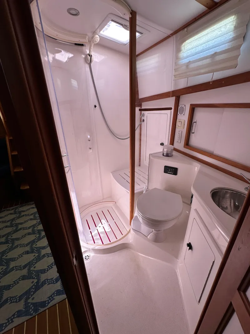 Slide: The Image of 2005 Sabre 38 Hardtop Express bathroom with shower, toilet, and sink. - 39