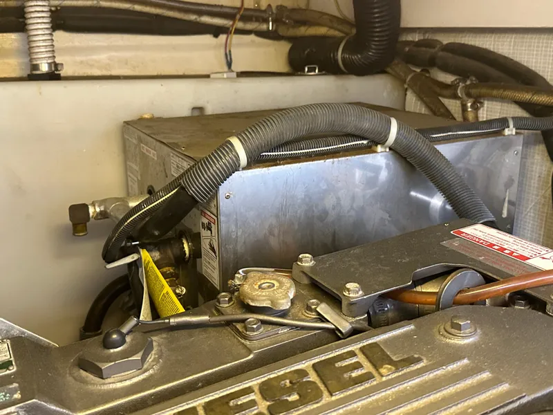 Slide: The Image of Engine compartment of a 2005 Sabre 38 Hardtop Express boat, featuring diesel components. - 41