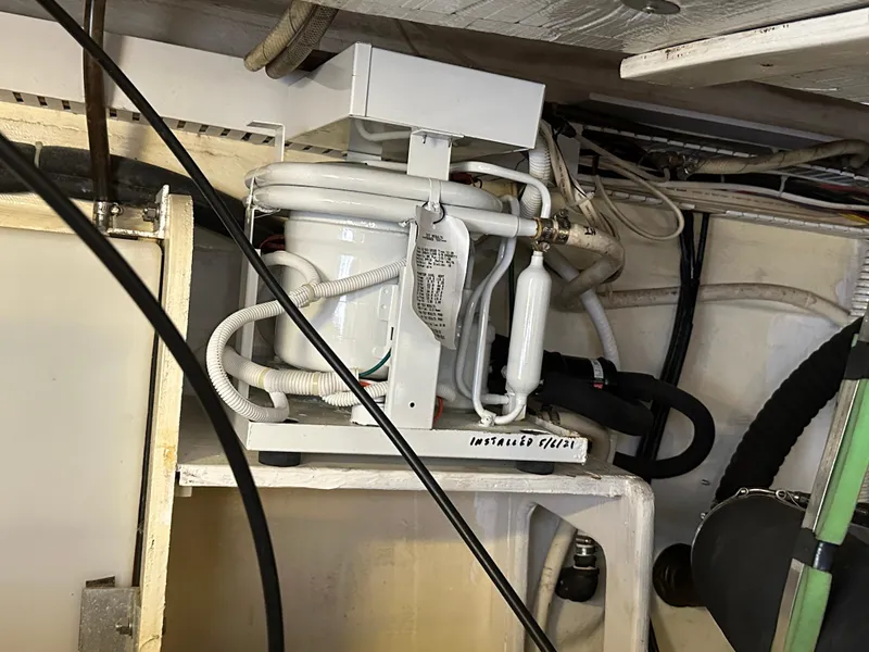 Slide: The Image of Engine room of 2005 Sabre 38 Hardtop Express with visible mechanical components and wiring. - 42