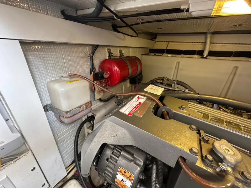 Slide: The Image of Engine room of 2005 Sabre 38 Hardtop Express with visible components and fire extinguisher. - 43