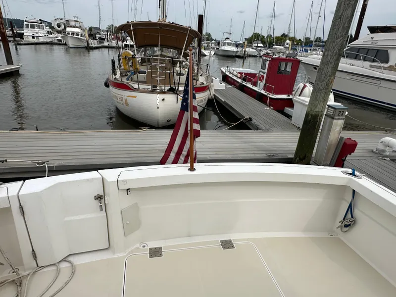Slide: The Image of 2005 Sabre 38 Hardtop Express docked at a marina with other boats. - 51