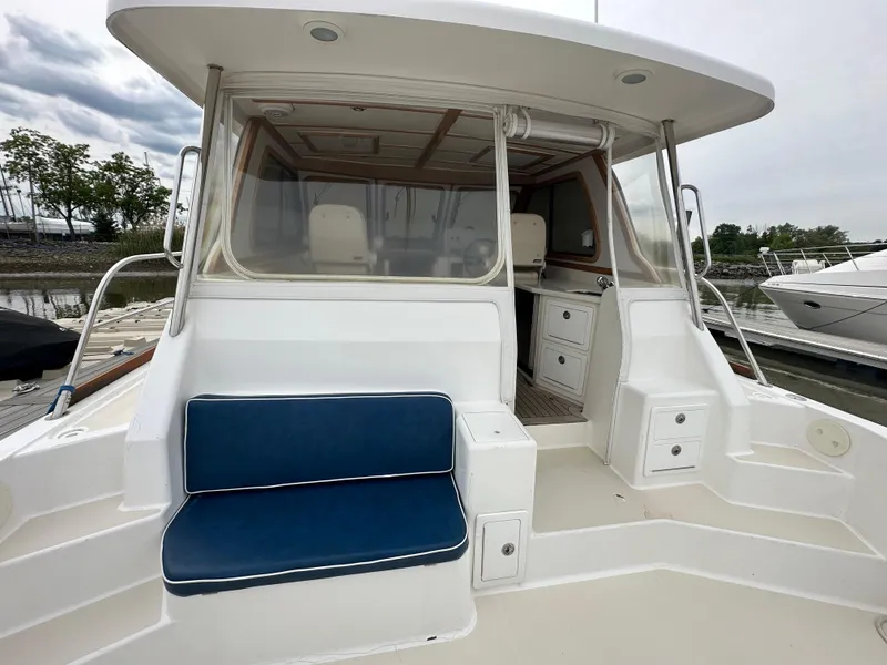 Slide: The Image of 2005 Sabre 38 Hardtop Express boat with blue seating and white deck. - 53