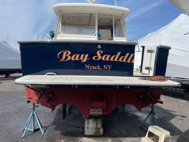 Slide: The Image of 2005 Sabre 38 Hardtop Express boat named "Bay Saddle" in Nyack, NY, on stands. - 6
