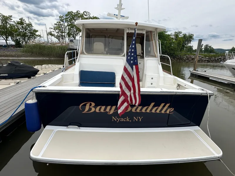 Slide: The Image of 2005 Sabre 38 Hardtop Express boat docked with American flag, named "Bay Paddle," Nyack, NY. - 9
