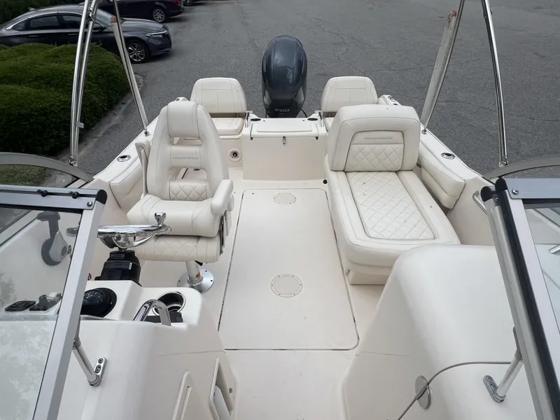 Slide: The Image of 2021 Grady-White Freedom 215 boat interior with white seating and steering console. - 13