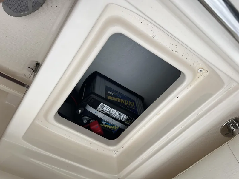 Slide: The Image of Battery compartment of 2021 Grady-White Freedom 215 boat, showing installed marine battery. - 16