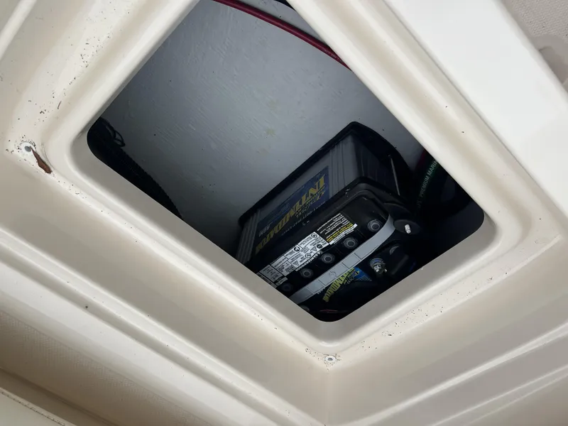 Slide: The Image of Battery compartment of 2021 Grady-White Freedom 215 boat, showing marine battery installation. - 17