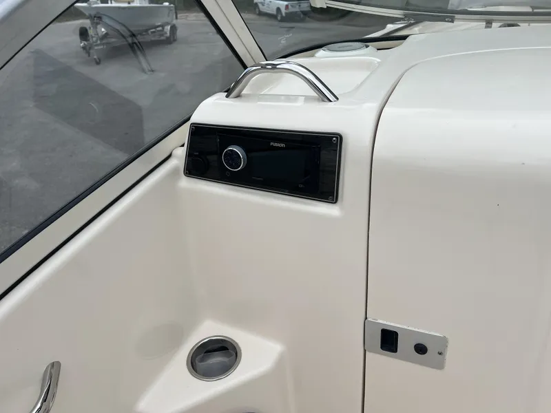 Slide: The Image of 2021 Grady-White Freedom 215 boat interior with audio system and cup holder. - 18