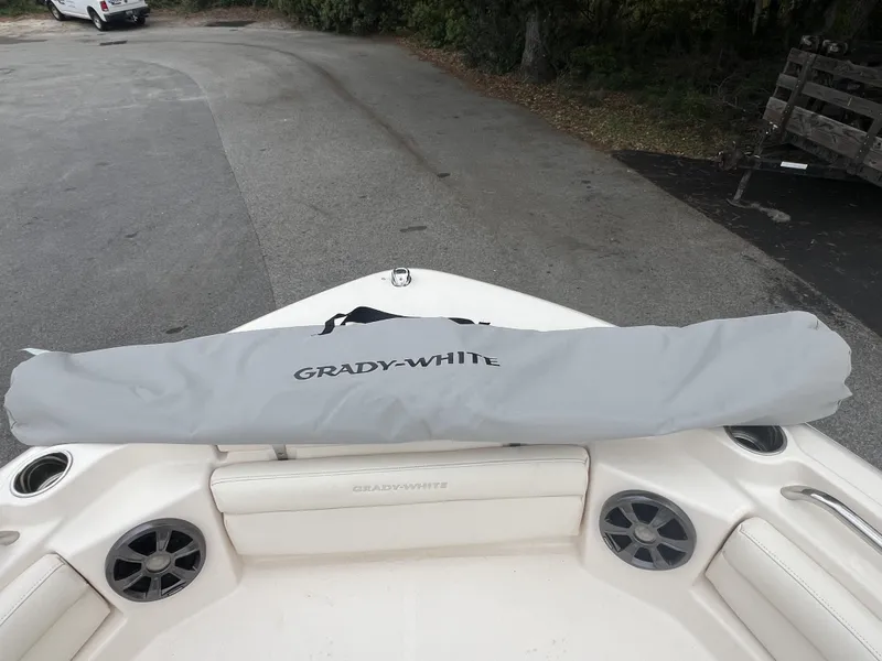 Slide: The Image of 2021 Grady-White Freedom 215 boat interior with cover, parked on pavement. - 6