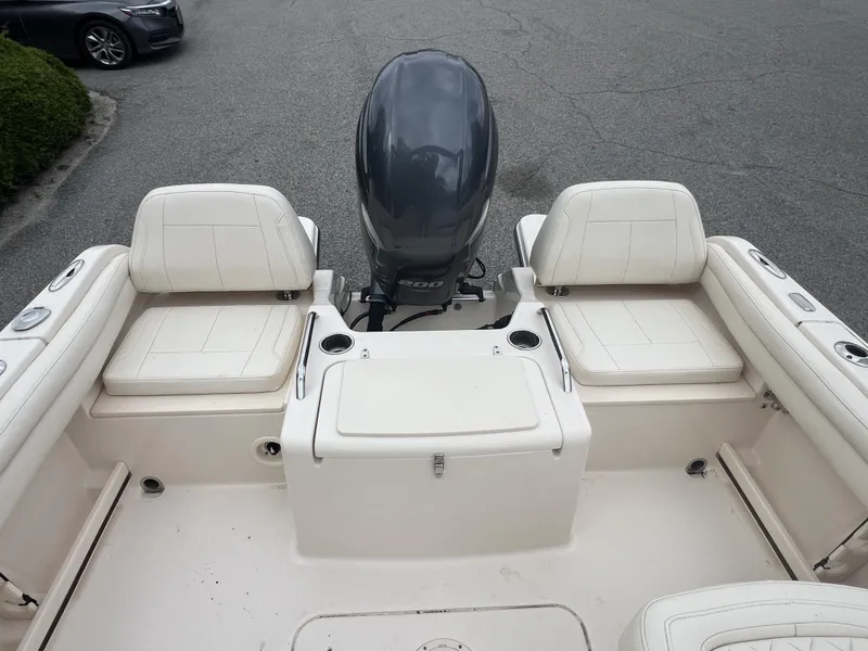 Slide: The Image of 2021 Grady-White Freedom 215 boat interior with seating and outboard motor. - 7