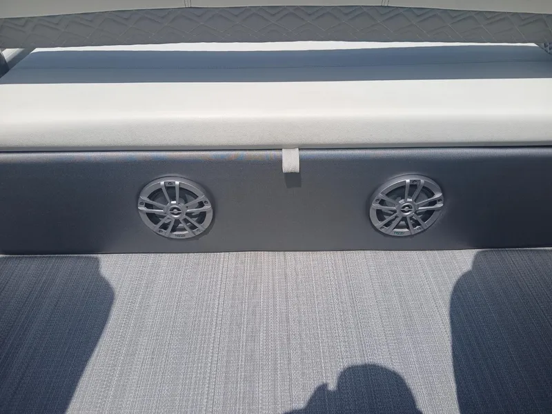 Slide: The Image of 2023 Veranda VP22VLC boat interior with dual speakers and cushioned seating. - 10