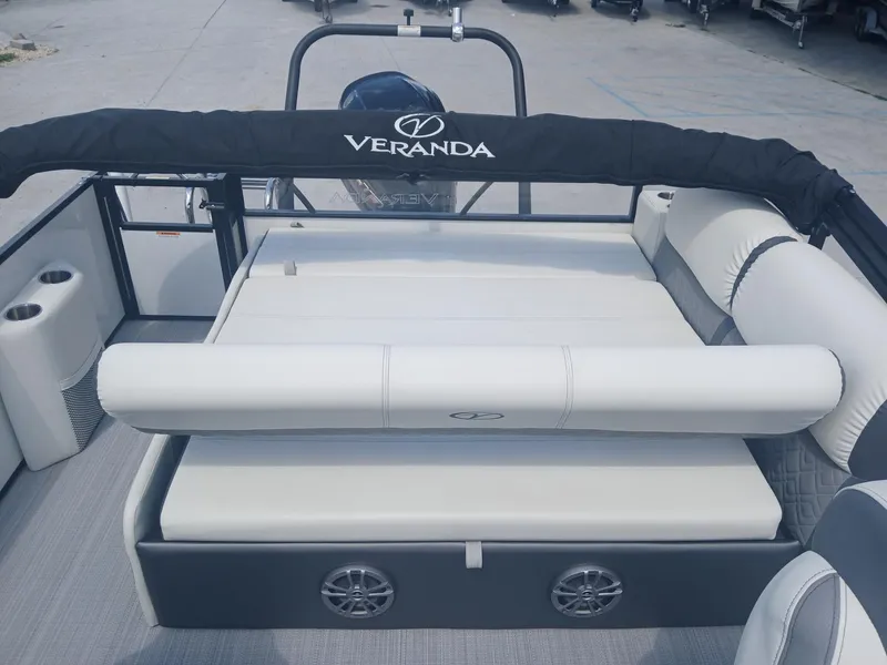 Slide: The Image of 2023 Veranda VP22VLC pontoon boat interior with cushioned seating and cup holders. - 19