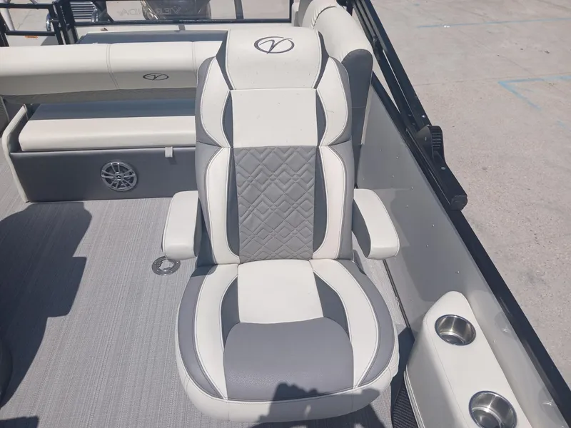 Slide: The Image of 2023 Veranda VP22VLC boat seat with gray and white upholstery, cup holders, and speaker. - 24